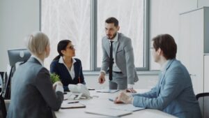 Fyra kollegor diskuterar vid ett konferensbord på ett kontor
